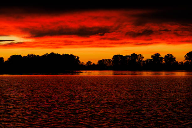 Cloudy orange sunset over Mincio river in Mantua, Italy