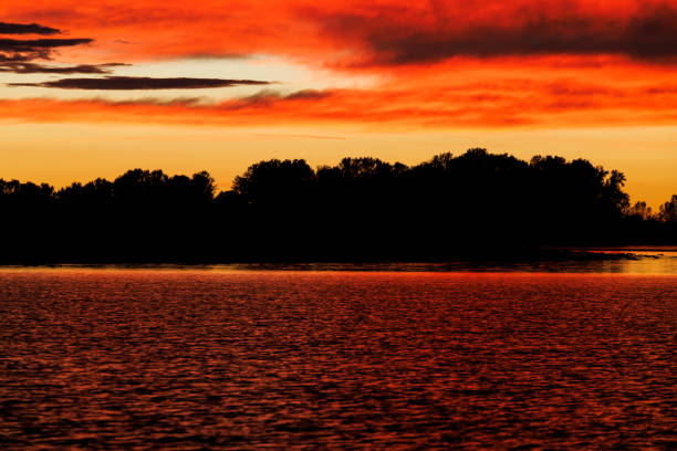 Cloudy orange sunset over Mincio river in Mantua, Italy