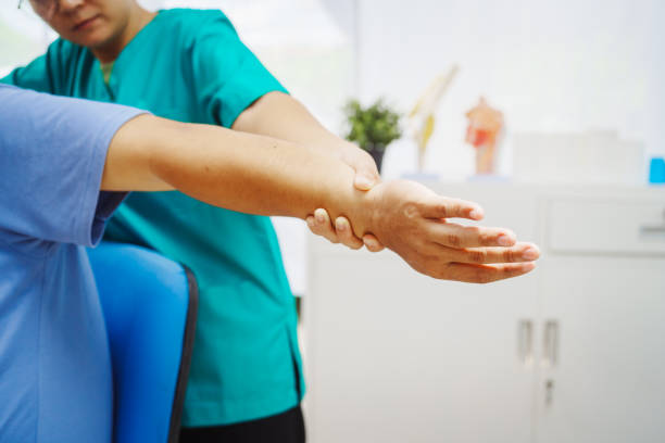 istock A female doctor performs physical therapy on a male patient in the hospital, using techniques like pulling, massaging, and compressing to rehabilitate injuries, relieve pain,restore daily functional 2189178484