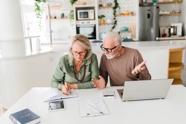 istock Senior couple using laptop while planning their home budget, 2189178842