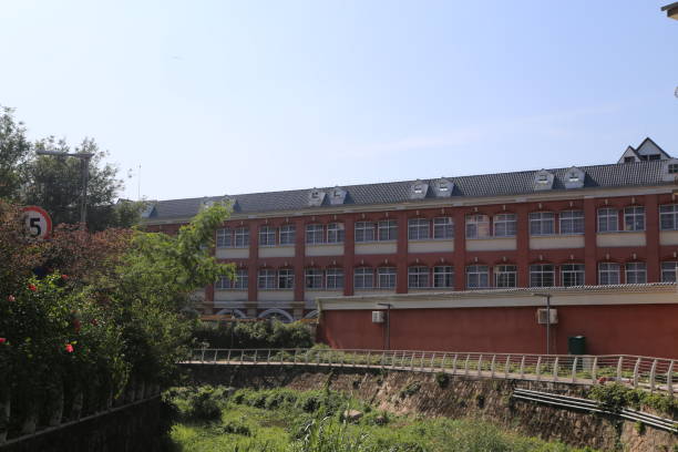 A large brick building with a green sign on the side that says 5
