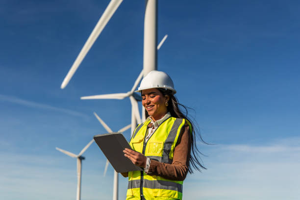 istock Latin american engineer inspecting wind turbines with digital tablet 2189180246
