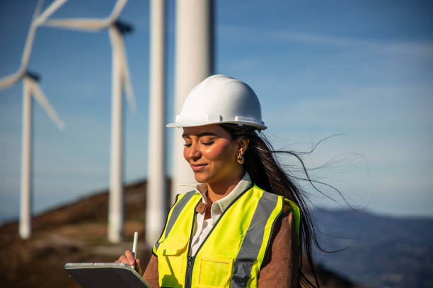 istock Female engineer inspecting wind turbines with digital tablet 2189180250
