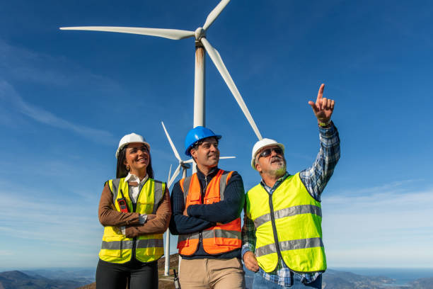 istock Engineers pointing at wind turbine in a wind farm generating green energy 2189180333