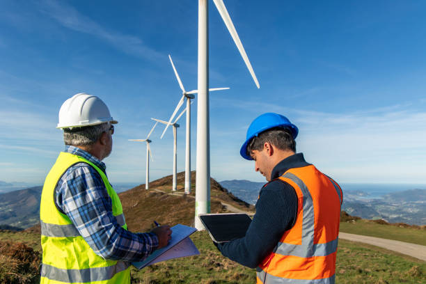istock Engineers inspecting wind turbines for green energy production 2189180828