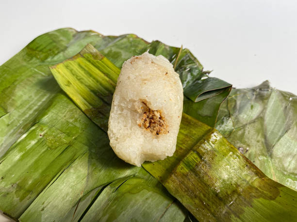 istock Lemper, is a snack made from glutinous rice, filled with meat floss, wrapped in banana leaf 2189180880
