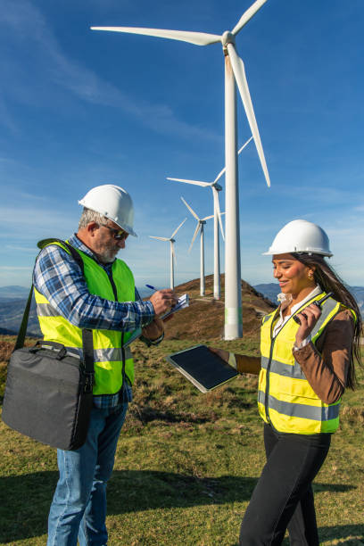 istock Engineers maintaining wind turbines in a green energy project 2189181024