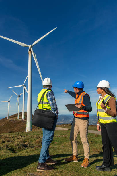 istock Engineers maintaining modern wind turbines in green energy farm 2189181336