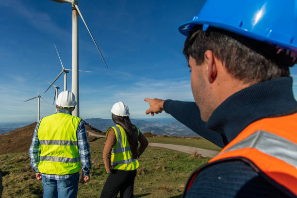 istock Engineers inspecting wind turbines in mountainous terrain 2189181344