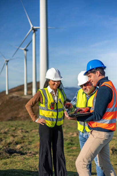 istock Engineers working together in a wind turbine power plant analyzing data on a laptop 2189181421