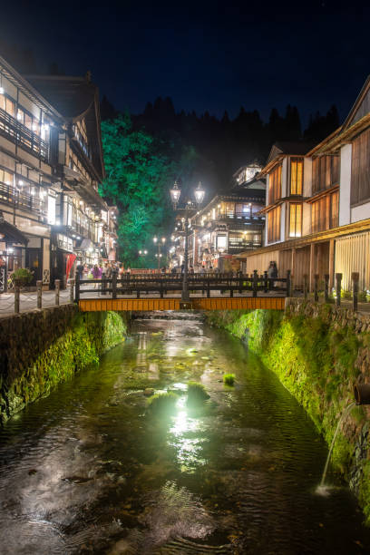 istock Ginzan onsen, Yamagata, Japan, Charming night scene with a bridge over a stream. 2189183227