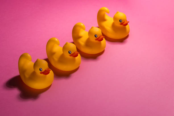 istock Charming Rubber Ducks Set Against a Delightful Pink Background for a Playful Vibe 2189186069