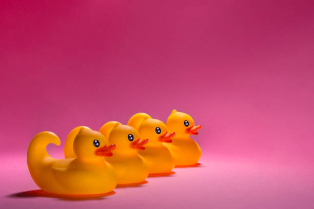 istock Adorable Cute Rubber Ducks Set Against a Lovely Pink Background for Maximum Cheerfulness 2189186333