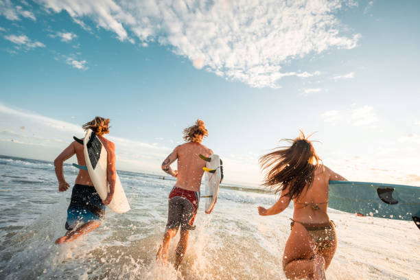istock Energetic Caucasian Friends Surf Waves at Sunrise 2189189077