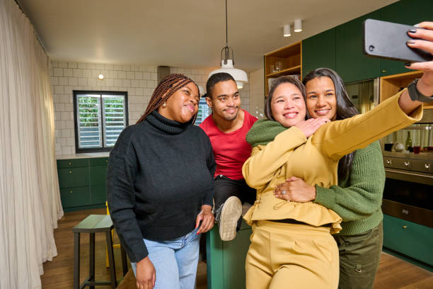 istock Smiling friends taking selfie at home 2189189538