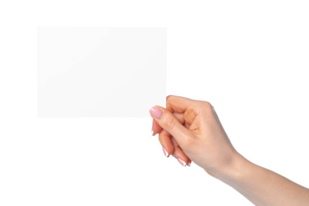 istock Woman's hand holding blank white sheet of paper isolated on white 2189190276