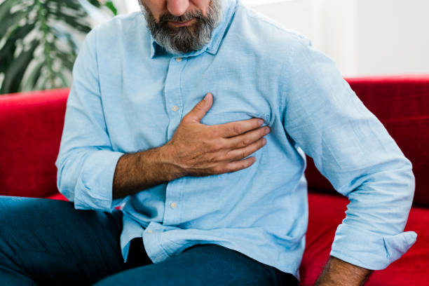 istock Senior man feeling unwell, suffering from backache, massaging aching muscles while sitting on sofa in the living room at home. Elderly and health issues concept 2189190591