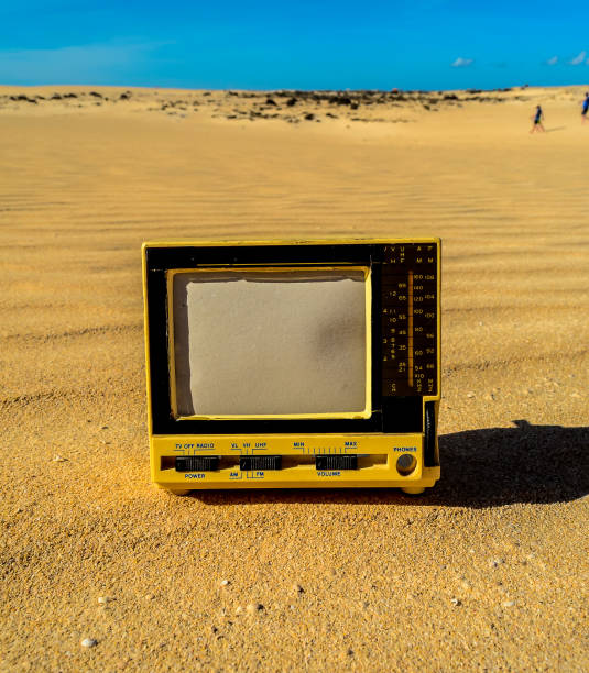 istock A yellow television is sitting on the sand in the desert 2189190672