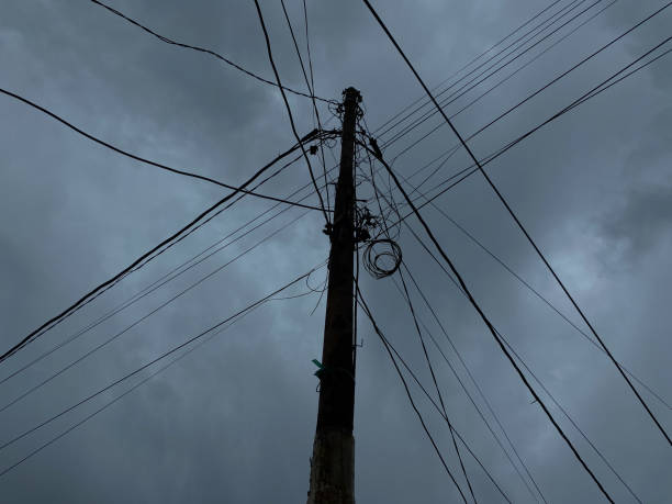 istock Power supply pole and cables, with dark cloudy sky background 2189190941