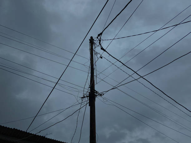istock Power supply pole and cables, with dark cloudy sky background 2189190964
