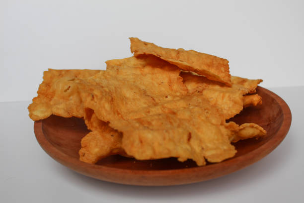 istock Kerupuk pangsit, or crispy fried thick skin dumpling, inside a white bowl, isolated in white background 2189191518