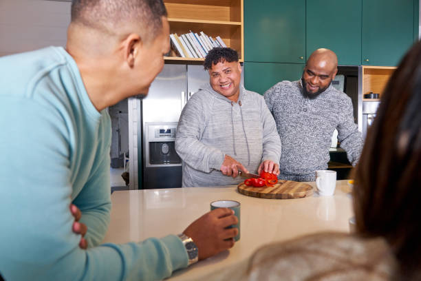 istock Smiling friends preparing food in kitchen 2189191923