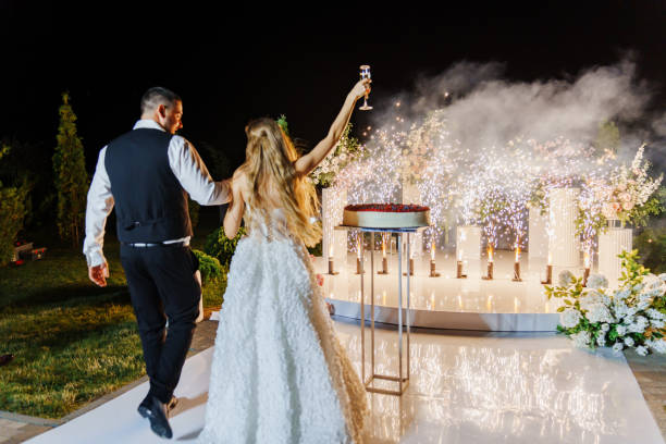 istock Bride and groom with a large round cake with berries. fireworks 2189193139