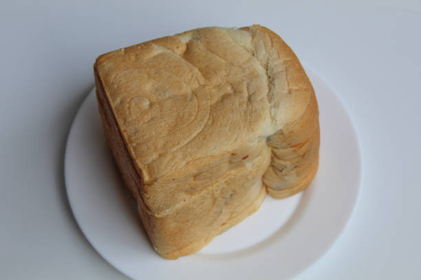 Half of a loaf of wheat bread isolated on white background. Free space for text.