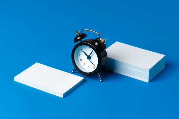 Mock up businesscard with black alarm clock, copy space