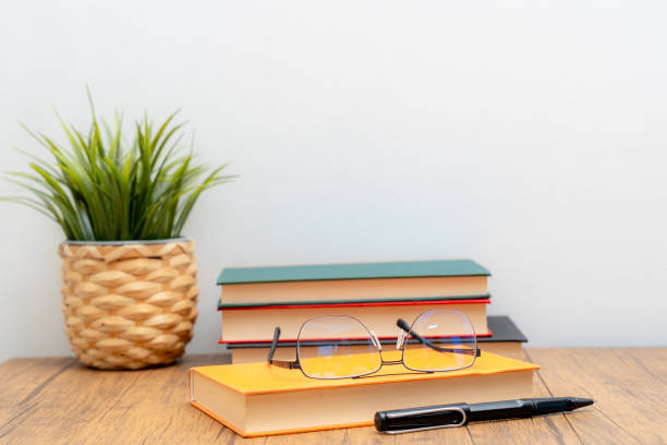 istock book eyeglass and pen on the table 2189194221