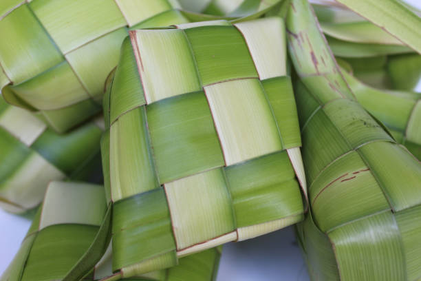 istock Ketupat wrap, woven young coconut leaves, before cooked. Isolated on white background 2189194259