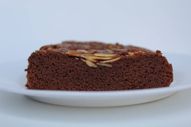 istock Brownies cake with almond topping, isolated on white background, side view 2189194794