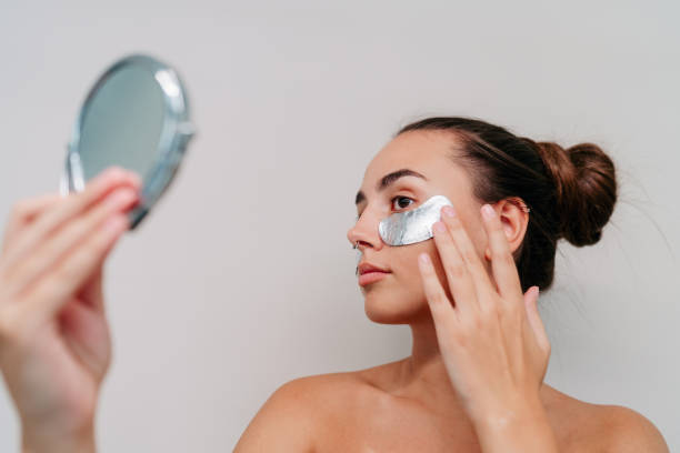 istock Beautiful young woman pampering herself with under-eye patches 2189196198