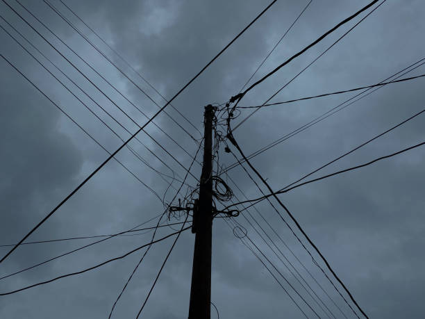 istock Power supply pole and cables, with dark cloudy sky background 2189197864
