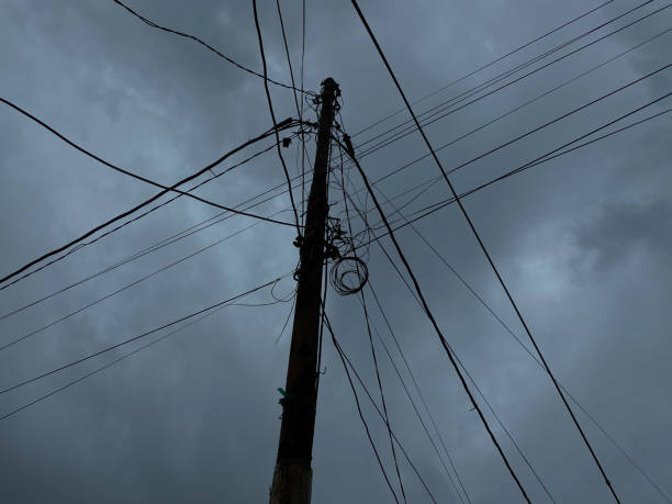 istock Power supply pole and cables, with dark cloudy sky background 2189197869