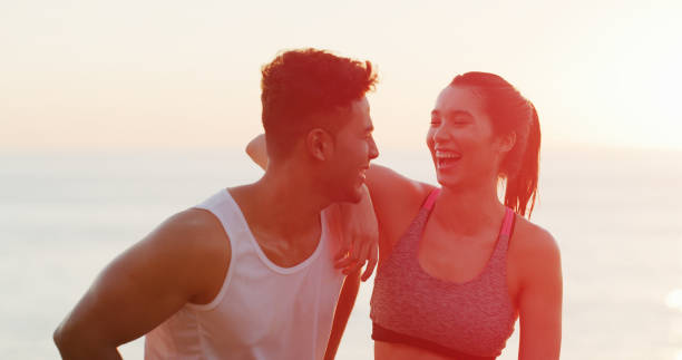 istock Fitness, laughing and exercise for couple, beach and bonding with workout, conversation and sports. Happy, athlete and people in morning, sea and communication for training, relax 2189199618