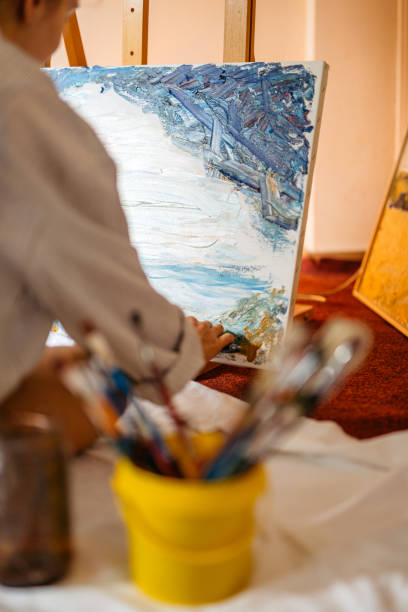 istock Young Female Artist Panting On The Floor At Home 2189202113
