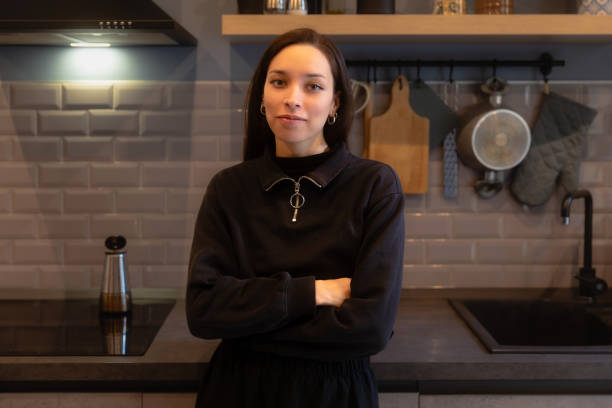 istock Confident Woman in a Modern Kitchen looking at camera 2189202401