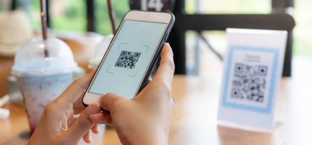 istock Woman use smartphone to scan QR code for order menu in cafe restaurant with a digital delivery. Choose menu and order accumulate discount. E wallet, technology, pay online, credit card, bank app. 2189203851