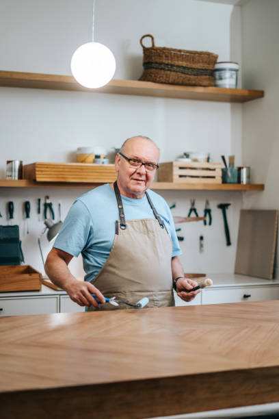 istock Senior carpenter working on furniture 2189204084
