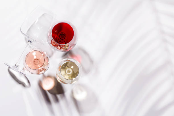 istock Three wine glasses filled with red, white, and rose wine 2189204553