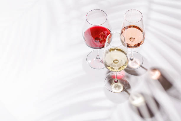 istock Three wine glasses filled with red, white, and rose wine 2189204602