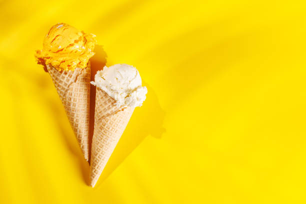 istock A refreshing ice cream cones set against a vibrant yellow background 2189205681