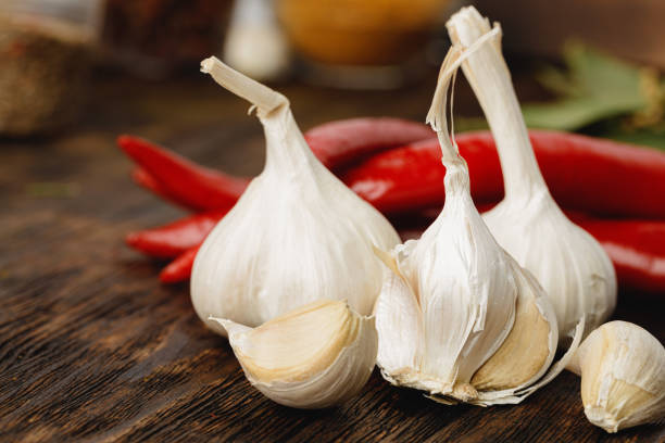 Garlic and red chili pepper on dark wooden table
