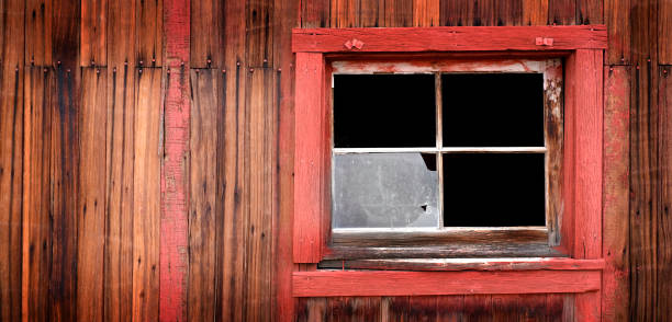 istock Old Weathered Barn Wall with Red Paint Windows and Nails 2189209214