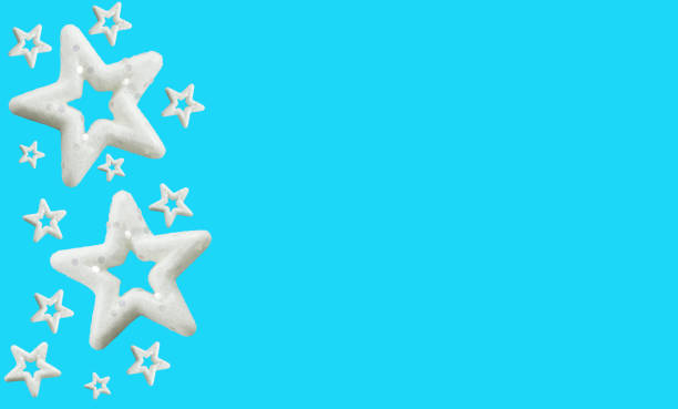 Festive white stars isolated on blue background with copy space. New Year stars. White stars with glitters, design element, red background. Isolated white stars, xmas decorations