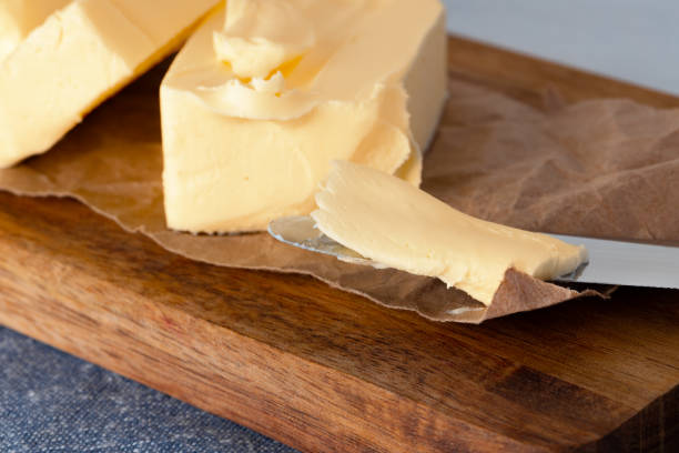 istock Wooden board with butter on blue checkered napkin 2189210283