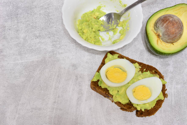 istock cooking a sandwich with eggs and an avocado on it 2189212156