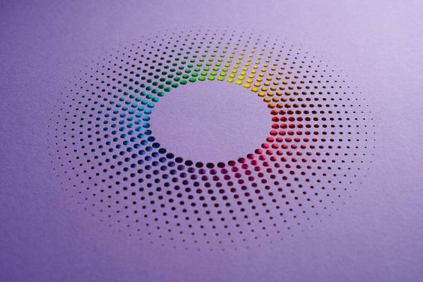 istock Circular perforated paper artwork with vibrant rainbow gradient on a soft purple background. 2189213695