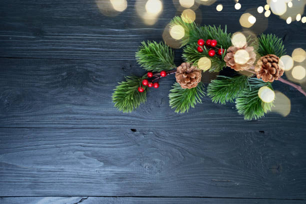 istock A Beautifully Crafted Festive Evergreen Arrangement Featuring Colorful Berries and Rustic Pine Cones on Dark Wood 2189214117